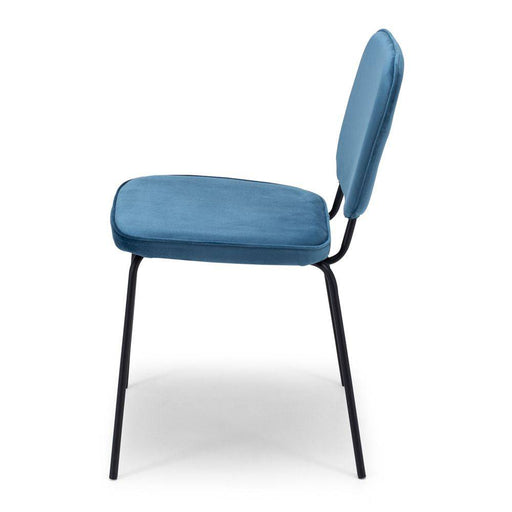 The Clyde Dining Chair finished in ocean blue velvet is slim-lined and elegant, adds a pop of colour around the dining table.