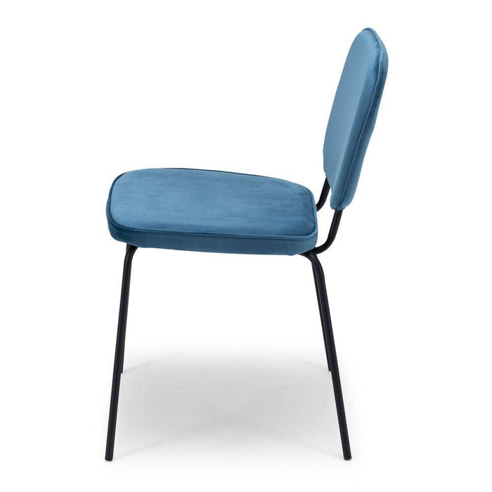The Clyde Dining Chair finished in ocean blue velvet is slim-lined and elegant, adds a pop of colour around the dining table.