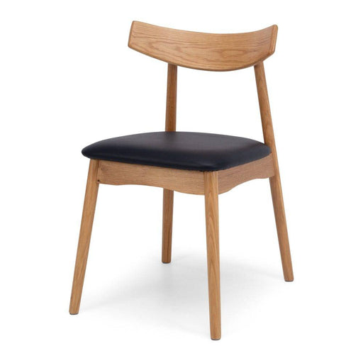 The sleek curving wood frame of the  Wagner Dining chair is made from solid white oak.