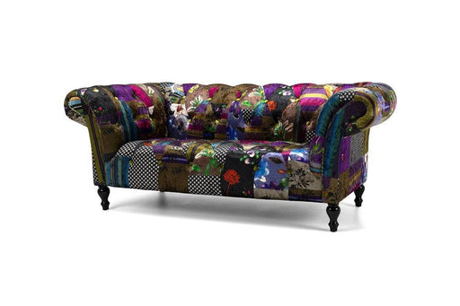  Stunning velvet patchwork loveseat with feature green velvet buttons in a traditional Chesterfield style. Finished with glossy black turned legs